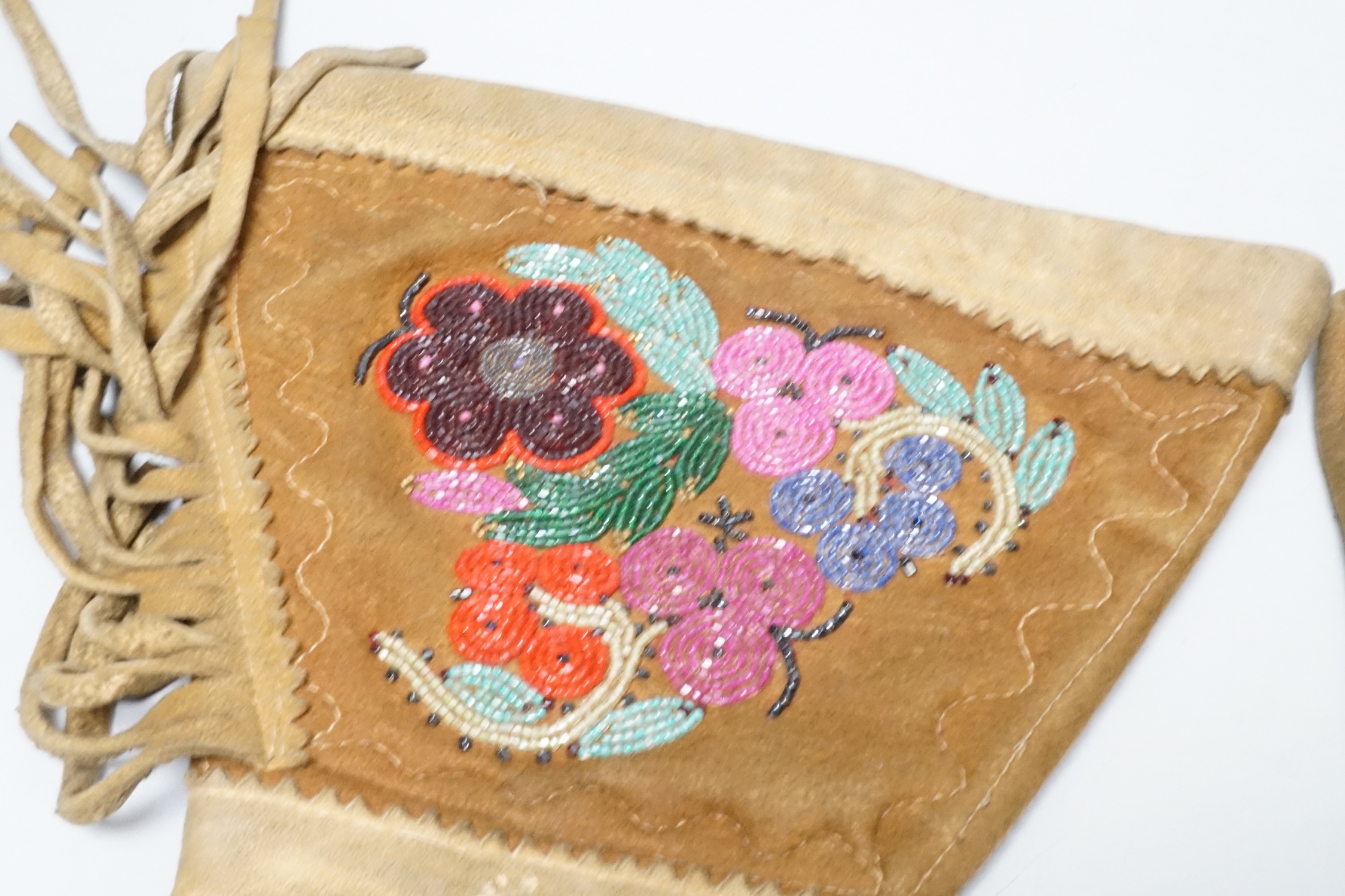 A pair of early 20th century native American suede and beaded gauntlet gloves, 39cm long